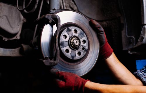 A mechanic working on a brake disc