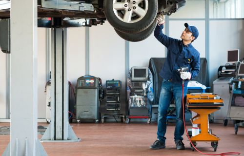 A mechanic performing a MOT test