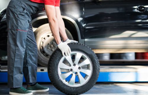 A mechanic replacing a tyre
