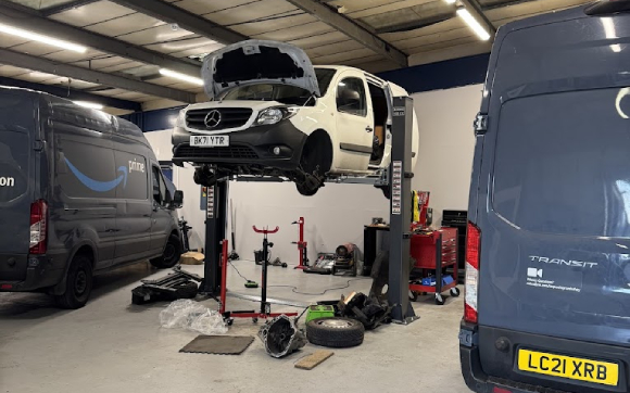 A van raised in the air on a ramp